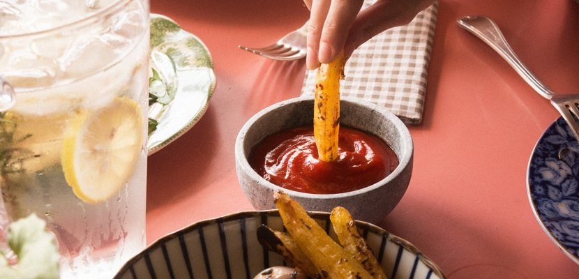 french fries dipped in ketchup